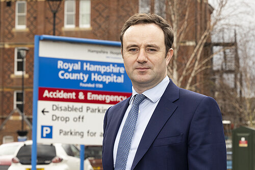 Danny in front of the Royal Hampshire County Hospital sign